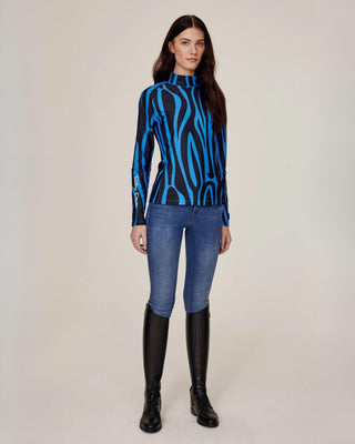 Full body front view of the blue zebra riding top styled with original denim riding breeches for a classic yet bold look.