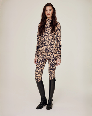 Full body front view of the complete leopard print equestrian set with matching top and supportive breeches.