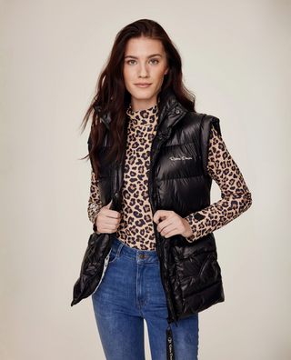 Medium front view of a model styling the Leo riding top under a black puffer vest with original denim breeches.