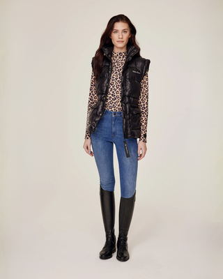 Full body front view of a complete equestrian outfit with a black vest, Leo riding top, and OG denim jeans.