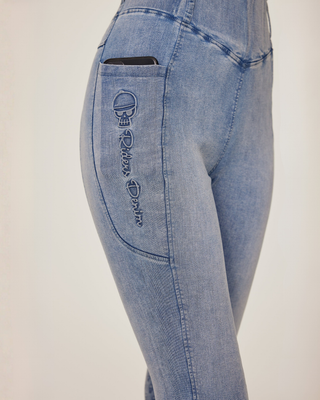 Close-up of the second phone pocket featuring the embroidered Riders Denim logo on light blue denim.