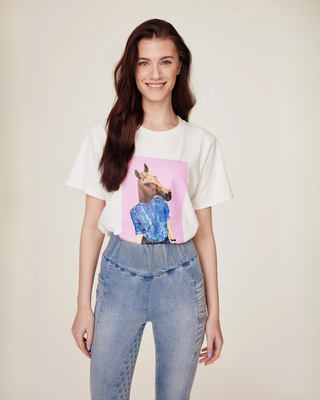 Front view from the knees up showcasing the light blue denim breeches paired with a white horse print t-shirt.