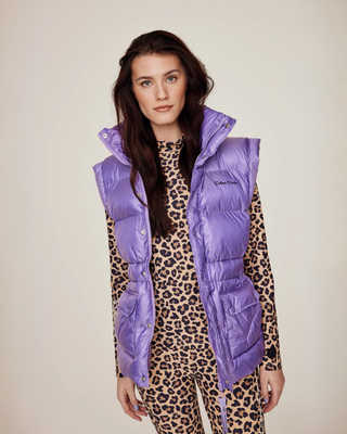 Model wearing the lilac riding vest unzipped, showcasing the complete leopard print riding set underneath.