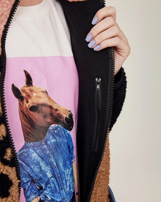 Close-up detail of the durable zipper and the interior pocket construction of the teddy riding jacket.