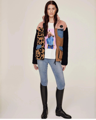 Full body view of the unzipped teddy jacket showing the white horse print t-shirt and light blue jeans breeches underneath.