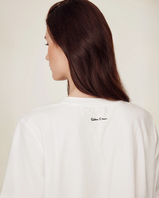 Back view product shot of the white riding t-shirt highlighting the premium cotton fit.